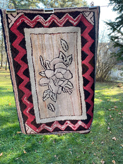 Floral Hooked rug with striking zig-zag border