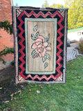 Floral Hooked rug with striking zig-zag border